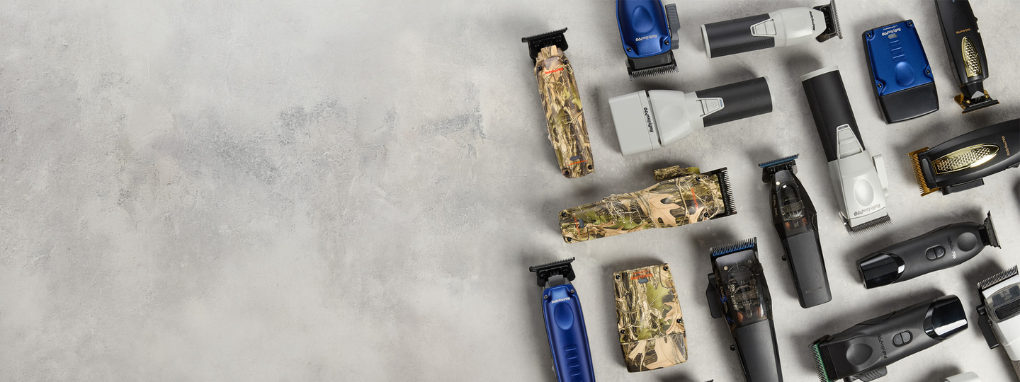 collection of barber tools in camo, blue, grey, and black colorways on a grey slab background.