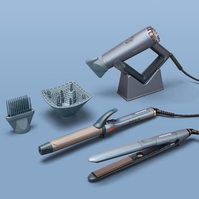 set of blue & grey hair styling tools featuring a square-shaped hair dryer, curling iron, and flat iron